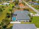 Aerial view of a home featuring a screened pool, surrounded by lush tropical vegetation at 265 White Marsh Ln, Rotonda West, FL 33947