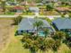 Aerial view highlighting a screened pool with lush tropical landscaping at 265 White Marsh Ln, Rotonda West, FL 33947