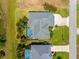 Aerial view showcasing a home with a screened pool, adjacent to a well-maintained lawn at 265 White Marsh Ln, Rotonda West, FL 33947