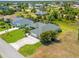 Inviting home showcasing well-maintained landscaping, a screened lanai, and an attached two-car garage at 265 White Marsh Ln, Rotonda West, FL 33947