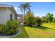 Lush backyard oasis featuring a screened-in lanai and decorative landscaping, perfect for outdoor relaxation at 265 White Marsh Ln, Rotonda West, FL 33947
