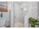 Bright bathroom featuring a toilet, a framed art piece and a walk-in shower with marble tiling at 265 White Marsh Ln, Rotonda West, FL 33947