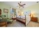 Cozy bedroom features a decorative wood-frame bed, soft carpeting, and relaxing green walls at 265 White Marsh Ln, Rotonda West, FL 33947