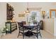 Bright dining room with a round table, comfortable chairs, and natural light from a window at 265 White Marsh Ln, Rotonda West, FL 33947