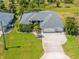 Beautiful home featuring a three-car garage, lush landscaping, and well-manicured lawn at 265 White Marsh Ln, Rotonda West, FL 33947