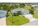 Well-manicured lawn leading to the home's entrance, complemented by lush palm trees and a charming American flag at 265 White Marsh Ln, Rotonda West, FL 33947