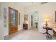 Inviting foyer with tile flooring, decorative glass door, and a glimpse into the home's stylish interior at 265 White Marsh Ln, Rotonda West, FL 33947