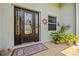 Elegant front door with decorative glass and sidelights complemented by a sunburst accent and potted plants at 265 White Marsh Ln, Rotonda West, FL 33947