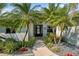 Charming front entrance with palm trees and tasteful landscaping creating a welcoming curb appeal at 265 White Marsh Ln, Rotonda West, FL 33947