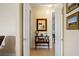 Hallway with decorative table, mirror, and doorways to other rooms, creating a welcoming transition at 265 White Marsh Ln, Rotonda West, FL 33947