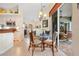 Eat-in kitchen with counter height seating, open to the lanai, and a chandelier over the table at 265 White Marsh Ln, Rotonda West, FL 33947