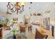 Open-concept living area with chandelier, kitchen island, dining table, and stainless steel appliances at 265 White Marsh Ln, Rotonda West, FL 33947