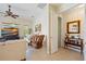Comfortable living room with ceiling fan, television, comfortable seating, and stylish decor at 265 White Marsh Ln, Rotonda West, FL 33947