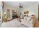 Spacious living room with neutral tones, a ceiling fan, and a decorative area rug at 265 White Marsh Ln, Rotonda West, FL 33947