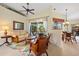 Comfortable living room area with seamless access to the screened-in lanai and adjoining dining space at 265 White Marsh Ln, Rotonda West, FL 33947