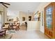 Open-concept living space with tile flooring, natural light, and seamless flow to the dining area and front door at 265 White Marsh Ln, Rotonda West, FL 33947