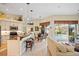 Open concept living room with kitchen, dining area, bar seating, and a view of the pool at 265 White Marsh Ln, Rotonda West, FL 33947