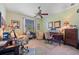 Spacious office featuring two work stations, soft carpeting, fan and natural lighting at 265 White Marsh Ln, Rotonda West, FL 33947