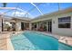 An inviting in-ground screened pool is surrounded by brick pavers and multiple entry points from inside the home at 265 White Marsh Ln, Rotonda West, FL 33947