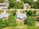Tranquil aerial shot of a single-story home bordered by trees, situated on a quiet street in a suburban neighborhood at 2685 Nanette Ln, North Port, FL 34286