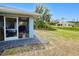Corner of patio looking out over backyard with lawn and a second house at 2685 Nanette Ln, North Port, FL 34286