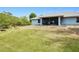 Expansive backyard with ample green space, with view of the screened in porch at 2685 Nanette Ln, North Port, FL 34286