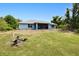 Expansive backyard with ample green space, leading to a screened patio area and natural landscape at 2685 Nanette Ln, North Port, FL 34286