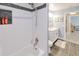 Bright bathroom featuring white subway tile in the shower, contrasting dark tile, and a white vanity at 2685 Nanette Ln, North Port, FL 34286