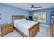 Charming bedroom with light blue walls, light wood furniture, and lots of natural light from the window at 2685 Nanette Ln, North Port, FL 34286