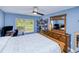Charming bedroom with light blue walls, light wood furniture, and lots of natural light from the window at 2685 Nanette Ln, North Port, FL 34286