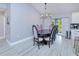 Elegant dining room featuring a modern light fixture and seating for eight guests at 2685 Nanette Ln, North Port, FL 34286