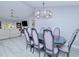 Dining room with modern lighting fixture in an open-concept floor plan at 2685 Nanette Ln, North Port, FL 34286