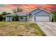Charming single-story home featuring a manicured lawn and a two-car garage at 2685 Nanette Ln, North Port, FL 34286