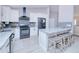 Modern kitchen featuring stainless steel appliances, a granite countertop, and sleek cabinetry at 2685 Nanette Ln, North Port, FL 34286
