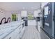 Open kitchen offers white cabinets, stainless appliances and granite island and counter tops at 2685 Nanette Ln, North Port, FL 34286