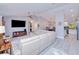 Bright living room featuring a modern sofa, large TV, and an open floor plan at 2685 Nanette Ln, North Port, FL 34286