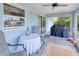 Screened patio equipped with ceiling fan and outdoor furniture, leading to the backyard area at 2685 Nanette Ln, North Port, FL 34286
