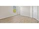Bedroom featuring a window, light wood floors, and neutral walls at 27237 Partin Dr, Punta Gorda, FL 33983