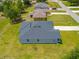 A modern home featuring a sleek gray exterior, a dark gray roof, and a well-maintained lawn at 27263 Deep Creek Blvd, Punta Gorda, FL 33983
