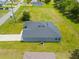 A modern home featuring a sleek gray exterior, a dark gray roof, and a well-maintained lawn at 27263 Deep Creek Blvd, Punta Gorda, FL 33983