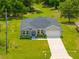 Aerial view of a home with a long driveway and manicured front yard at 27263 Deep Creek Blvd, Punta Gorda, FL 33983
