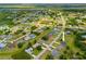 An aerial view of a neighborhood with houses, green spaces, and a river in the distance at 27263 Deep Creek Blvd, Punta Gorda, FL 33983