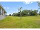 Expansive backyard featuring a lush green lawn and beautiful, mature trees providing ample shade at 27263 Deep Creek Blvd, Punta Gorda, FL 33983