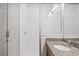 Bright bathroom with glass shower, granite countertop vanity, and wood-look laminate flooring at 27263 Deep Creek Blvd, Punta Gorda, FL 33983