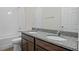 Bathroom featuring a double sink vanity with granite countertop and a bathtub with white tile surround at 27263 Deep Creek Blvd, Punta Gorda, FL 33983
