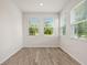 Bright bedroom with three windows offering a view and light-colored, wood-look laminate flooring at 27263 Deep Creek Blvd, Punta Gorda, FL 33983