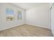 Bright bedroom with wood-look flooring and two windows providing ample natural light at 27263 Deep Creek Blvd, Punta Gorda, FL 33983