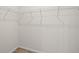 Walk in closet with laminate wood flooring and metal storage shelves at 27263 Deep Creek Blvd, Punta Gorda, FL 33983