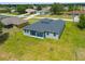 A modern home featuring a sleek gray exterior, a dark gray roof, and a well-maintained lawn at 27263 Deep Creek Blvd, Punta Gorda, FL 33983