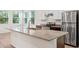 Modern kitchen with stainless steel appliances, granite countertops, and an island with a sink and faucet at 27263 Deep Creek Blvd, Punta Gorda, FL 33983